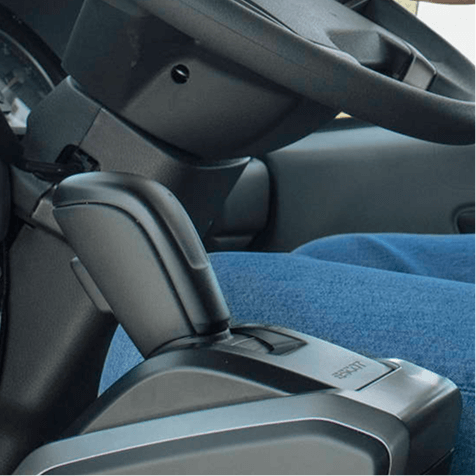 Close-up of a car interior showing a gear shift and steering wheel.