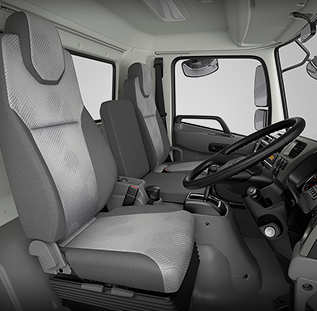 Gray truck cabin interior with two seats, steering wheel, and dashboard.