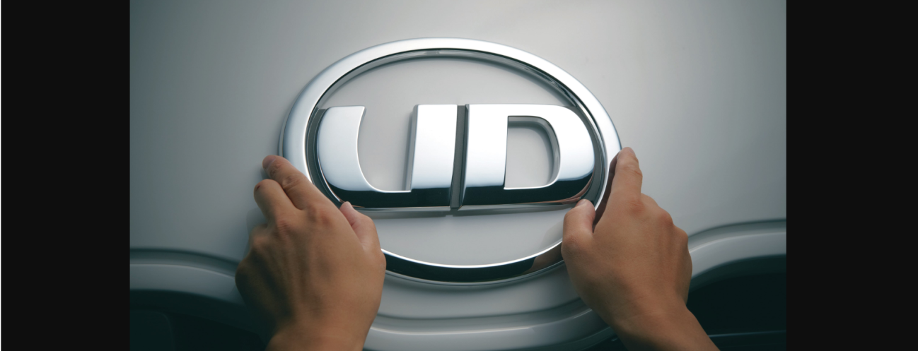 両手でUDロゴを持つ場面