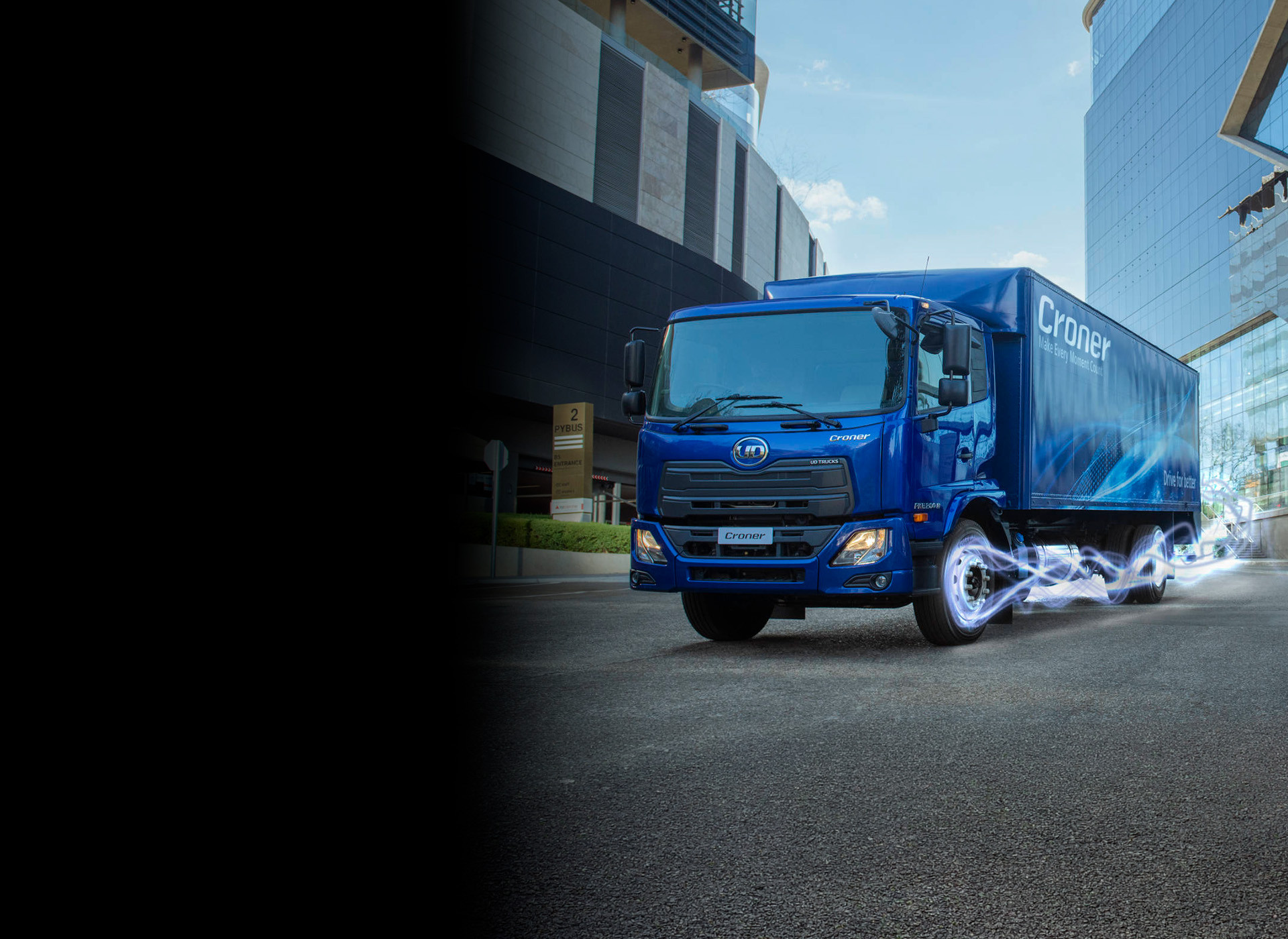 Blue delivery truck driving on city street with motion effects around wheels.