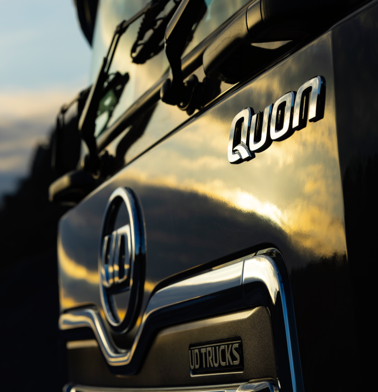 Sunset reflecting off the shiny front of a Quon truck.