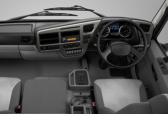 Modern truck dashboard with steering wheel, instrument cluster, and gray interior seats.